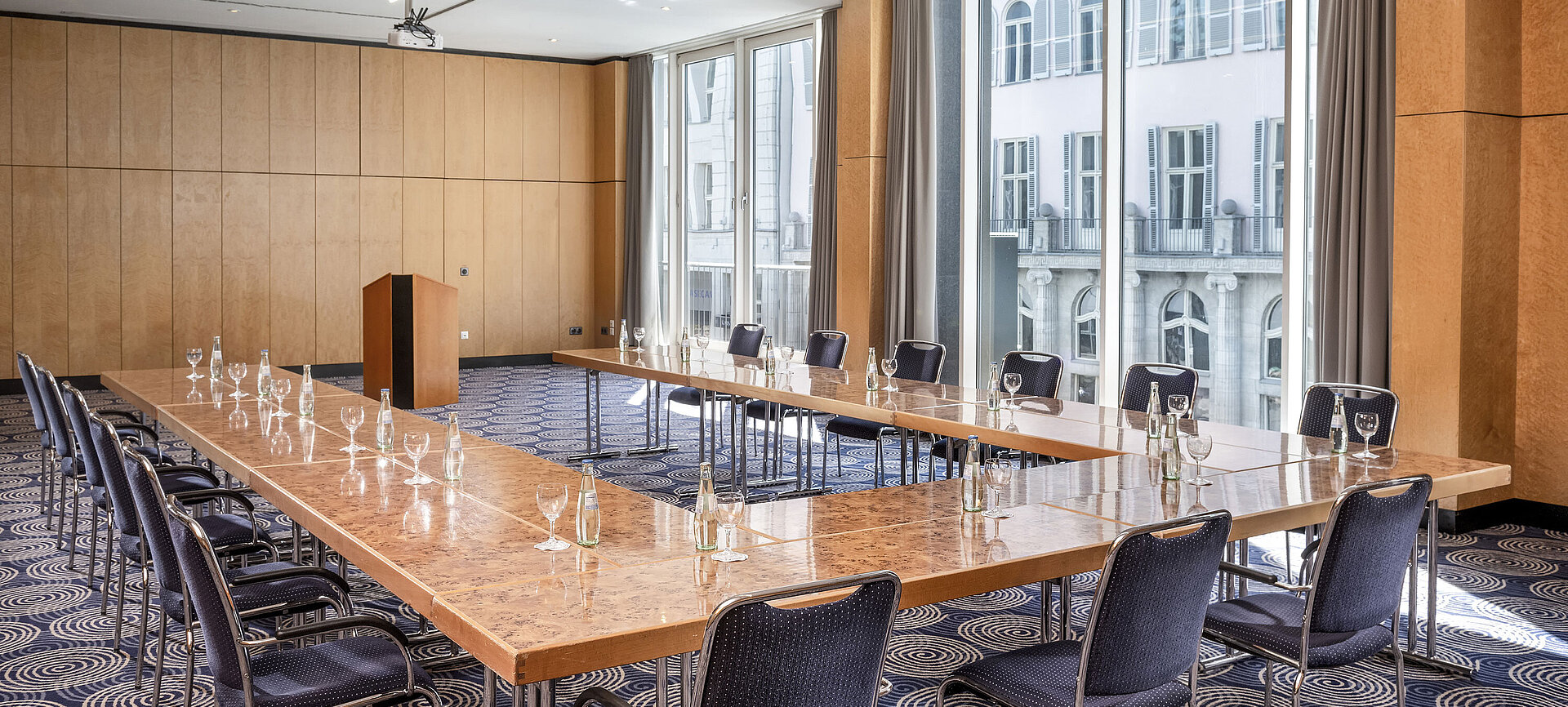 Conference room Salon II at Maritim proArte Hotel Berlin, large U-shaped table with outside view.