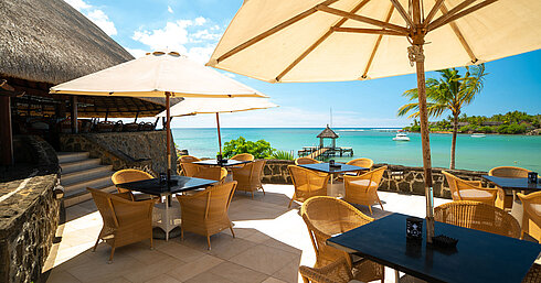 Quarter Deck Bar Beach restaurant with sun umbrellas, sea view and jetty for relaxed dining at Maritim Resort
