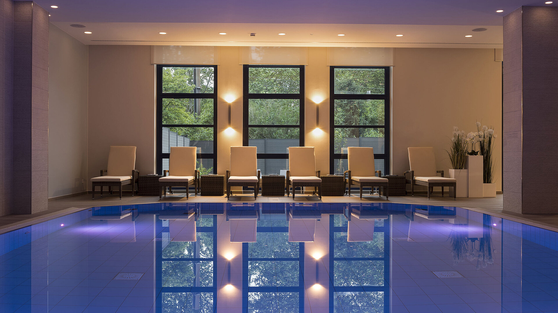 Pool Pool area at Maritim Hotel Bonn with stylish loungers and calming lighting for ultimate relaxation.