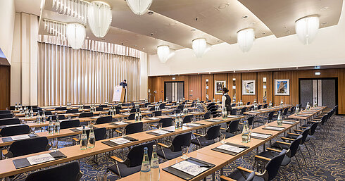  Large conference room at Maritim Hotel Frankfurt with row seating, stage, and modern facilities. 