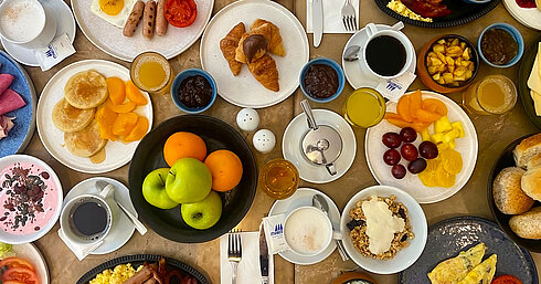 Les Jardins Restaurant Extensive breakfast at Les Jardins Restaurant at Maritim Antonine Hotel & Spa Malta featuring egg dishes, pancakes, croissants, fruit, yoghurt, granola, juices and coffee.