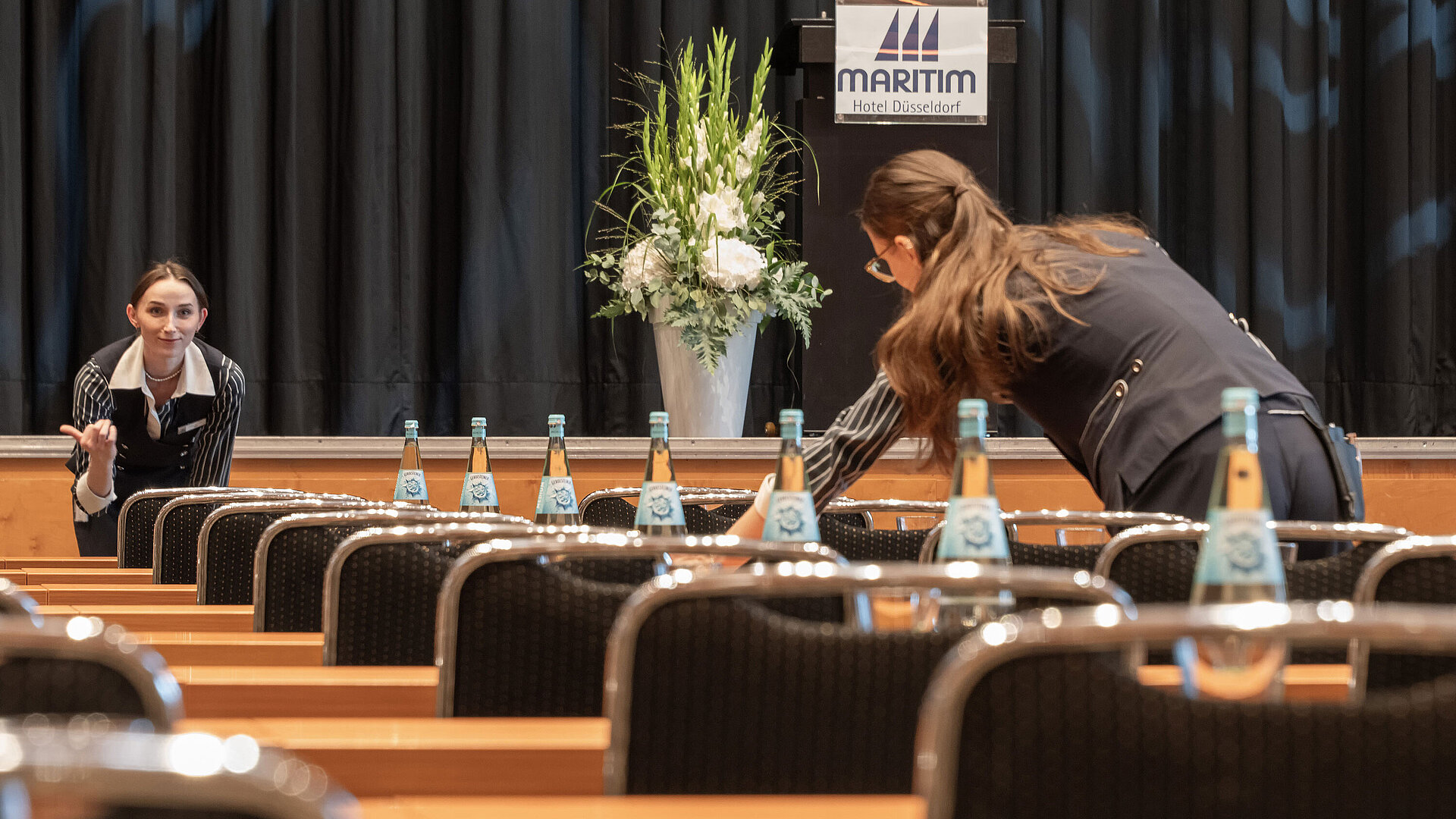 Staff prepare conference room with stage at Maritim Hotel Düsseldorf
