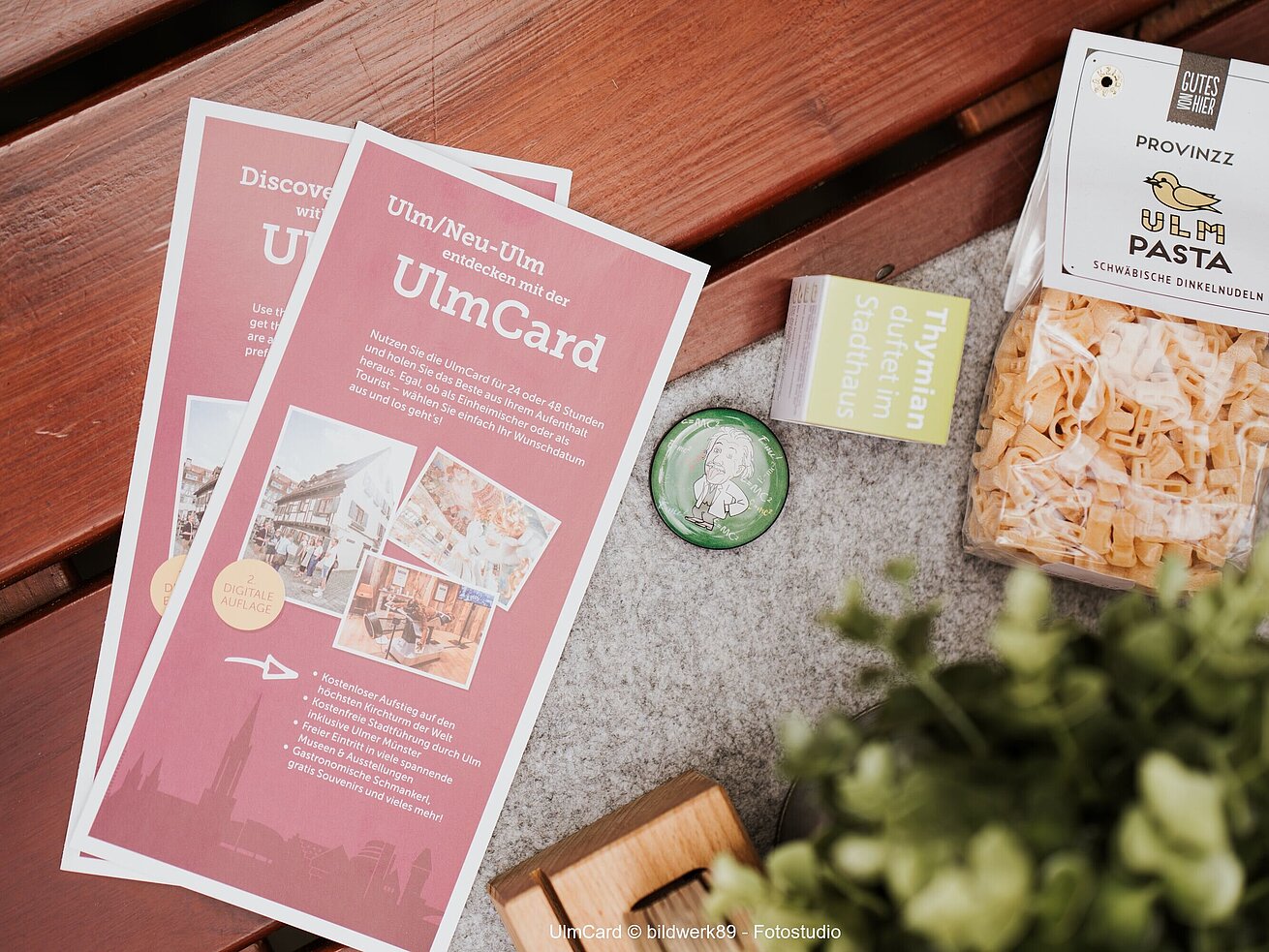 Information leaflet about the UlmCard with city map and brochures on a table.