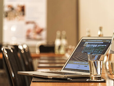 Detail view of meeting room Laptop, pen and glass of water on table in the conference room at the Maritim Hotel Munich