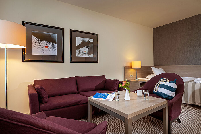 Classic Family room Cosy seating area in the Classic Family Room at Maritim Hotel Königswinter with sofa, armchairs and coffee table.