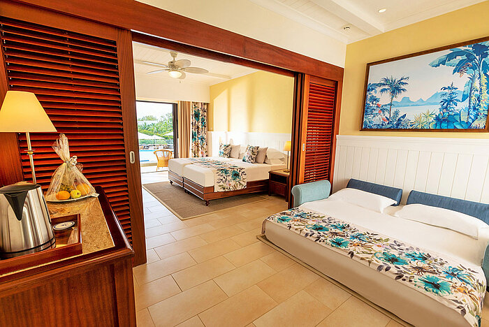 A spacious family room with two beds and direct access to the pool