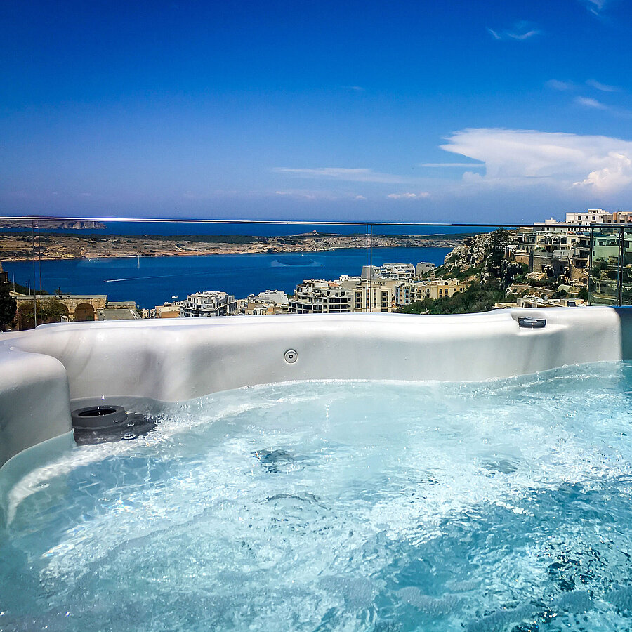 Hot tub with sea view Outdoor hot tub with stunning views of the sea and coastline
