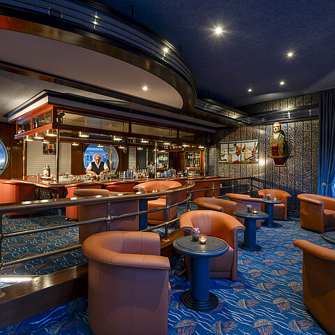 Stylish bar with cozy armchairs and nautical decor at Maritim Seehotel Timmendorfer Strand.