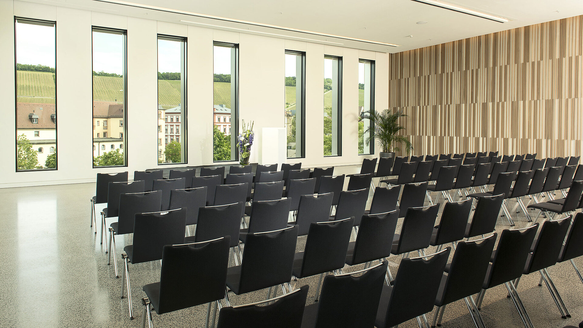 Modern event room at Maritim Hotel Würzburg with vineyard view and tall windows