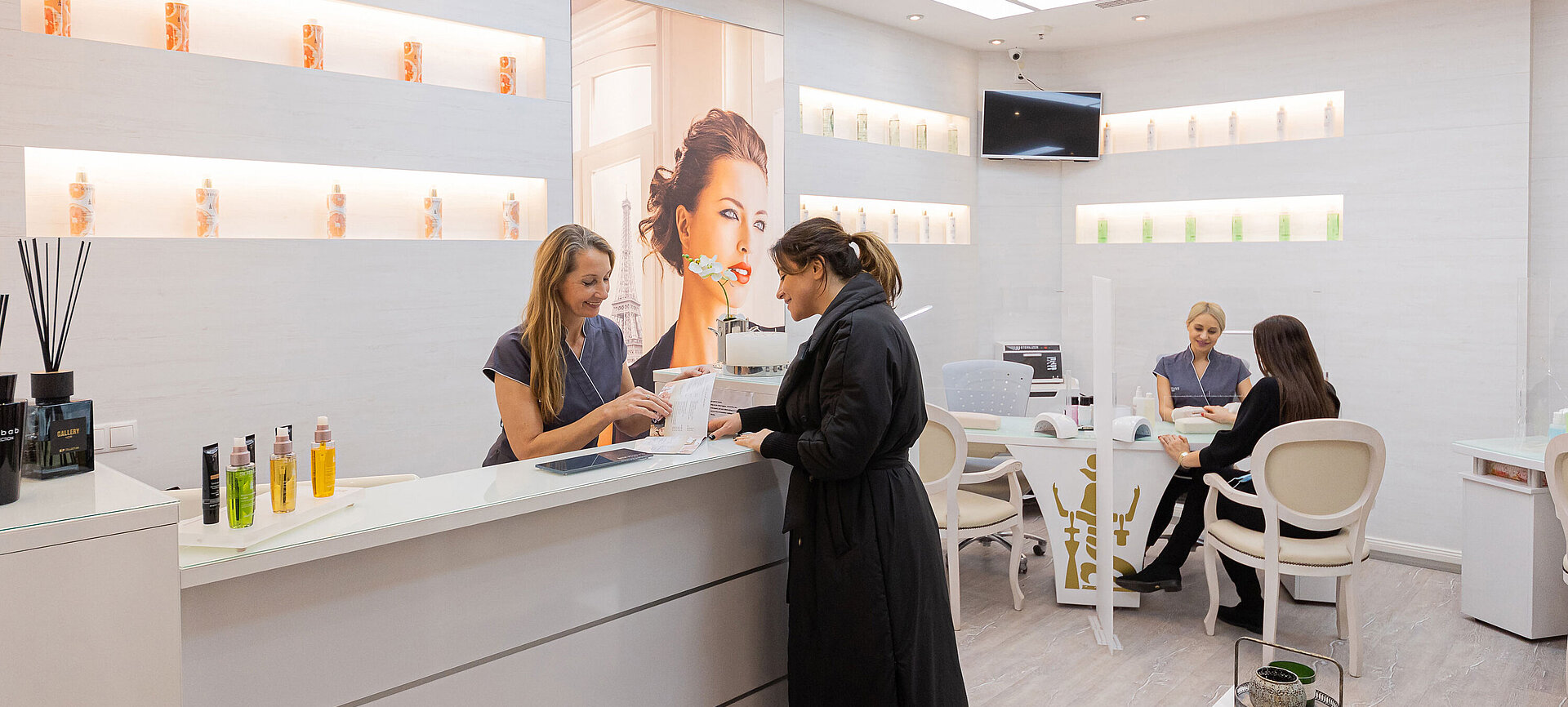 Reception area of the wellness area in the Maritim Hotel Bonn, where a customer receives friendly advice from a member of staff.