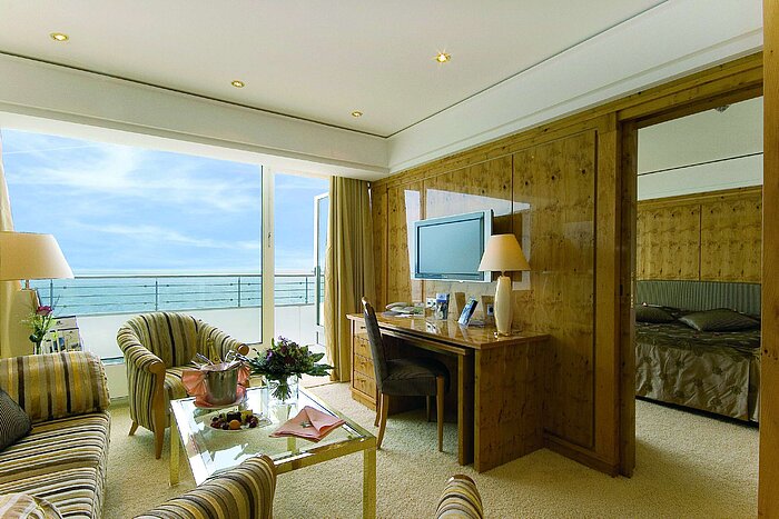 Penthouse suite at Maritim Seehotel Timmendorfer Strand with sea view, living area, and separate bedroom.