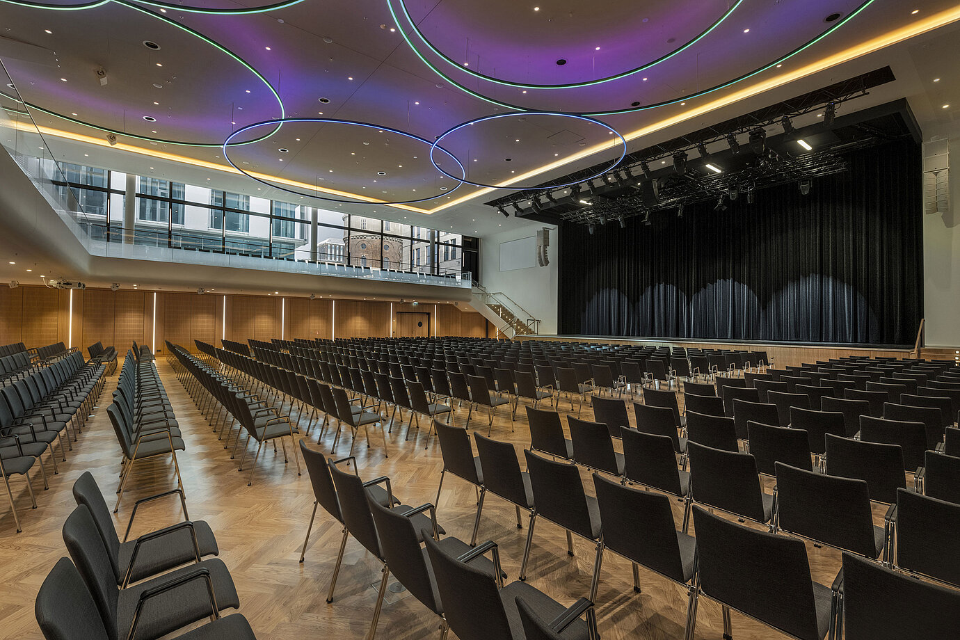 Modern event hall at Maritim Hotel Ingolstadt with stylish LED lighting and large stage.
