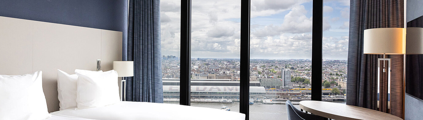 Double room with large window and view of Amsterdam at Maritim Hotel