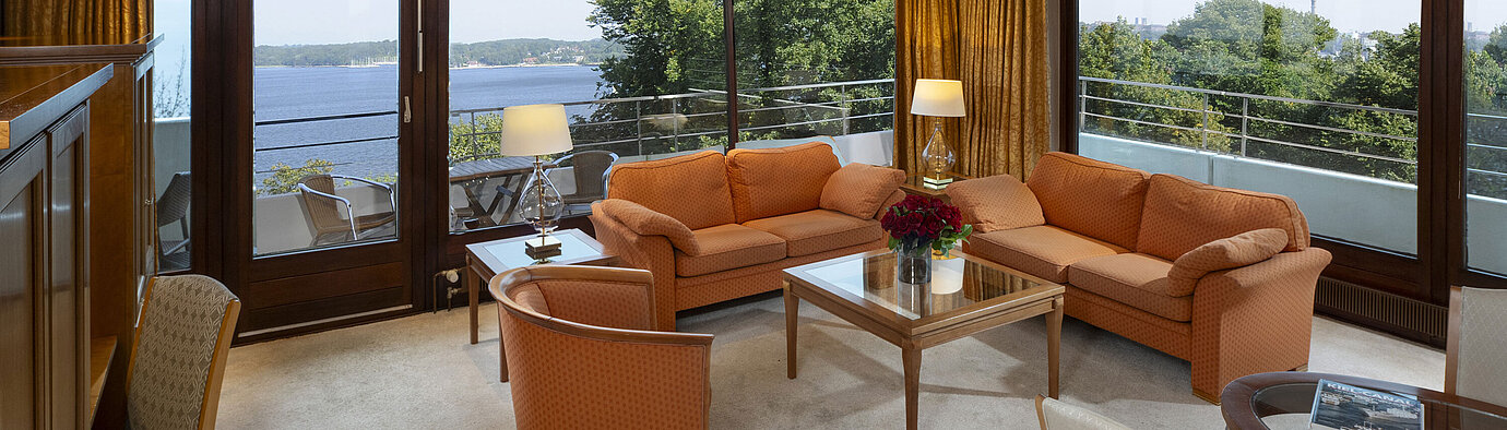 Presidential Suite Bright living area of the presidential suite at Maritim Hotel Kiel with panoramic Baltic Sea view and stylish furniture.