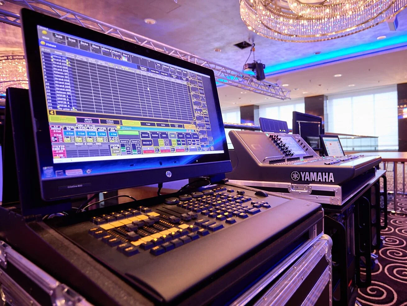 Modern event technology in a conference room Professional lighting and mixing console in a modern event space with stage setup.