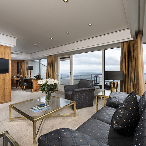 Penthouse living area with sea view, elegant furnishings, and large glass front at Maritim Seehotel Timmendorfer Strand.