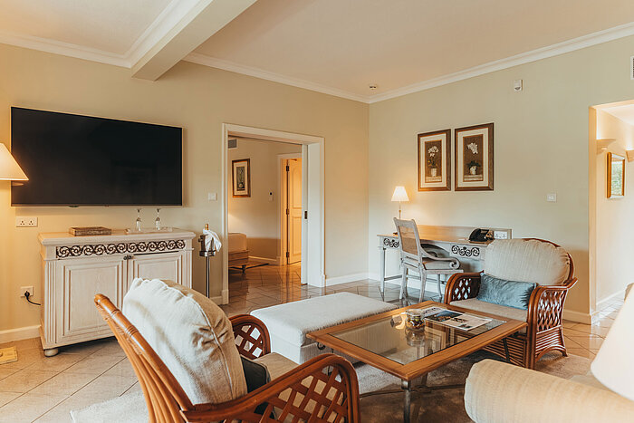 Spacious living area of the Penthouse Suite with seating area, dining table and elegant furnishings.