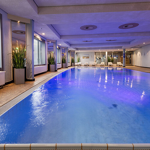 Pool Illuminated indoor pool at Maritim Hotel Frankfurt with a relaxing atmosphere and panoramic windows.