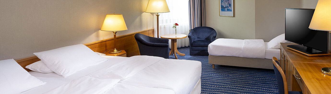 Classic Family room Classic family room with two beds, desk, flat-screen TV