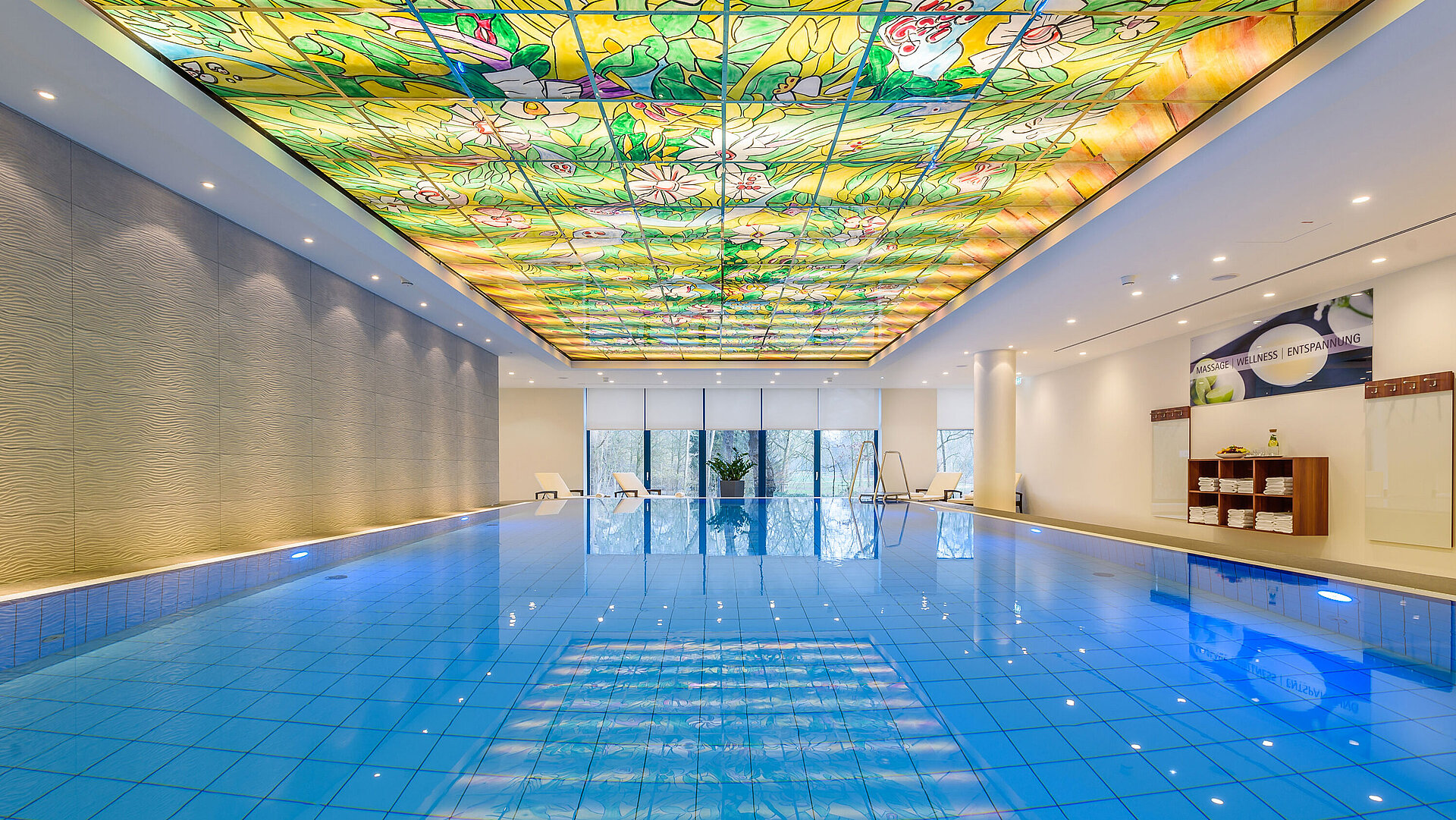 Elegant pool area at Maritim Hotel Bremen with colorful glass ceiling and modern lighting,perfect for wellness and relaxation