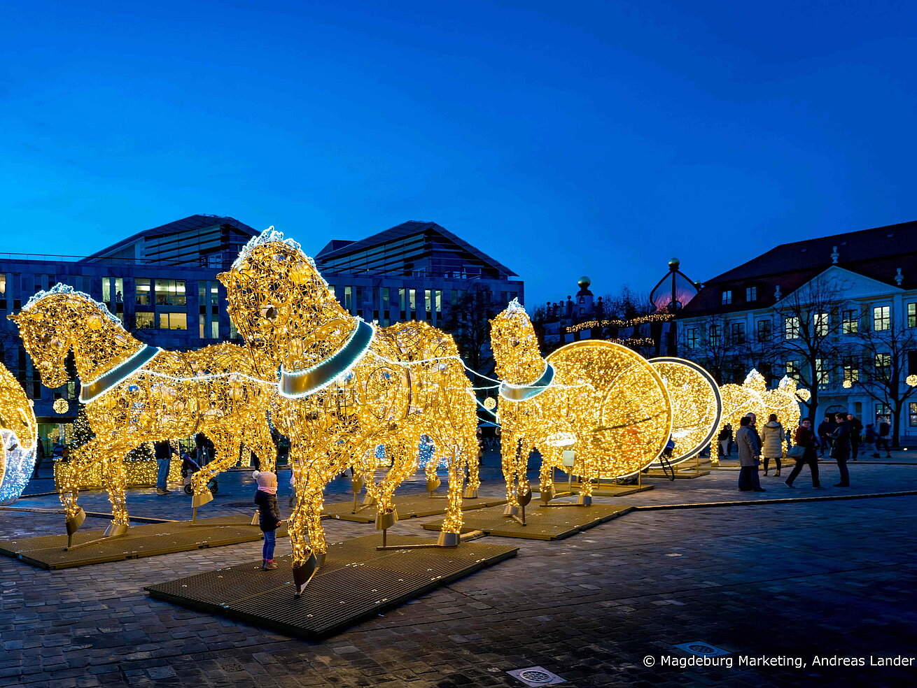 Magdeburg light world Festive illuminated figures and light installations at Magdeburg Light World at dusk.