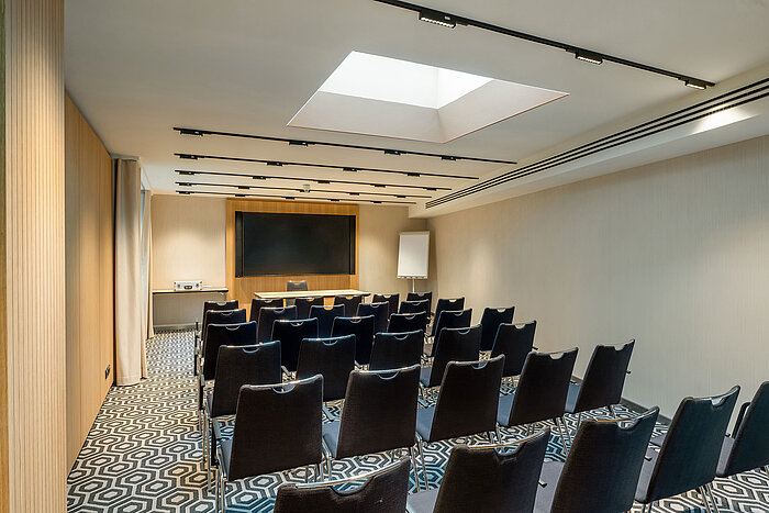 Meeting room 2 with theatre-style seating, modern presentation technology and a professional setting.