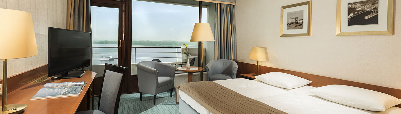 Superior room Superior room at the Maritim Hotel Kiel with desk, seating area, large double bed and balcony overlooking the fjord.