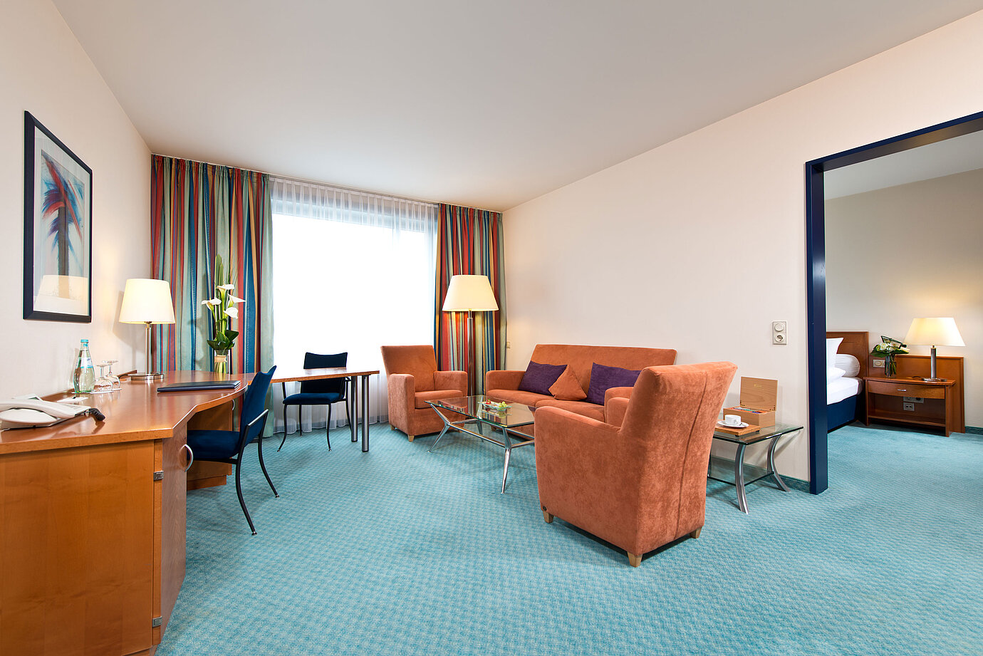 Elegant master suite at Maritim Hotel Frankfurt with separate bedroom, spacious living room, and modern amenities.