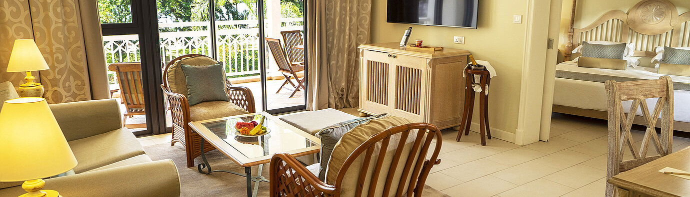 Spacious living area with TV, comfortable seating, and direct access to the bedroom