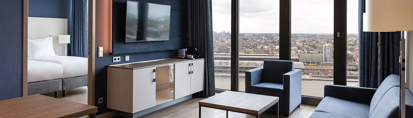 Modern living area with city view and TV at Maritim Hotel Amsterdam
