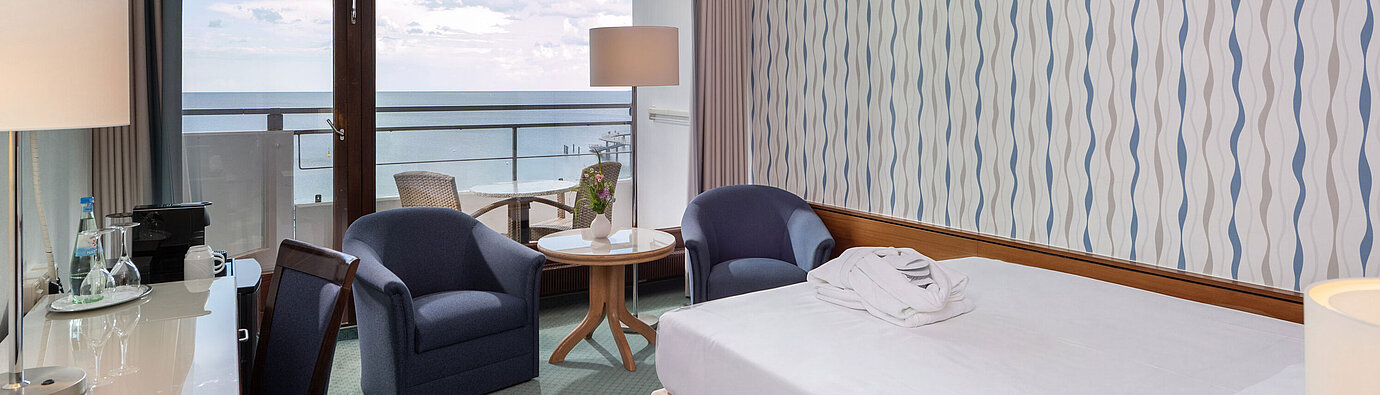 Superior Queen room with queen-size bed, seating area and large window with a view