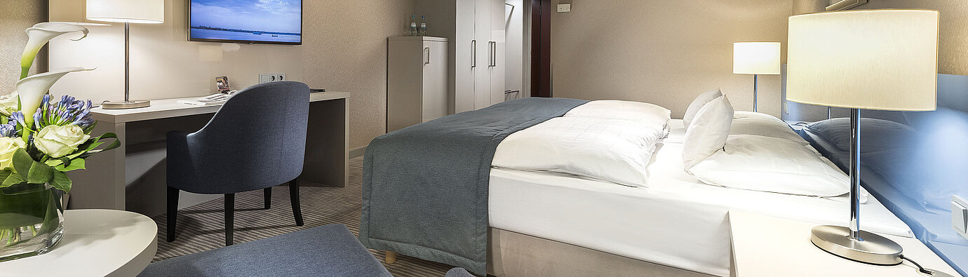 Superior room at Maritim Hotel Bonn with double bed, desk, TV, and modern decor. Comfortable and elegant.
