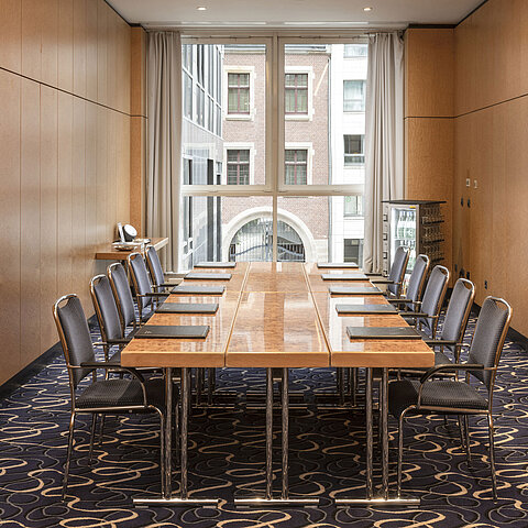 Elegant conference room at Maritim proArte Hotel Berlin with table and chairs in a modern setting.