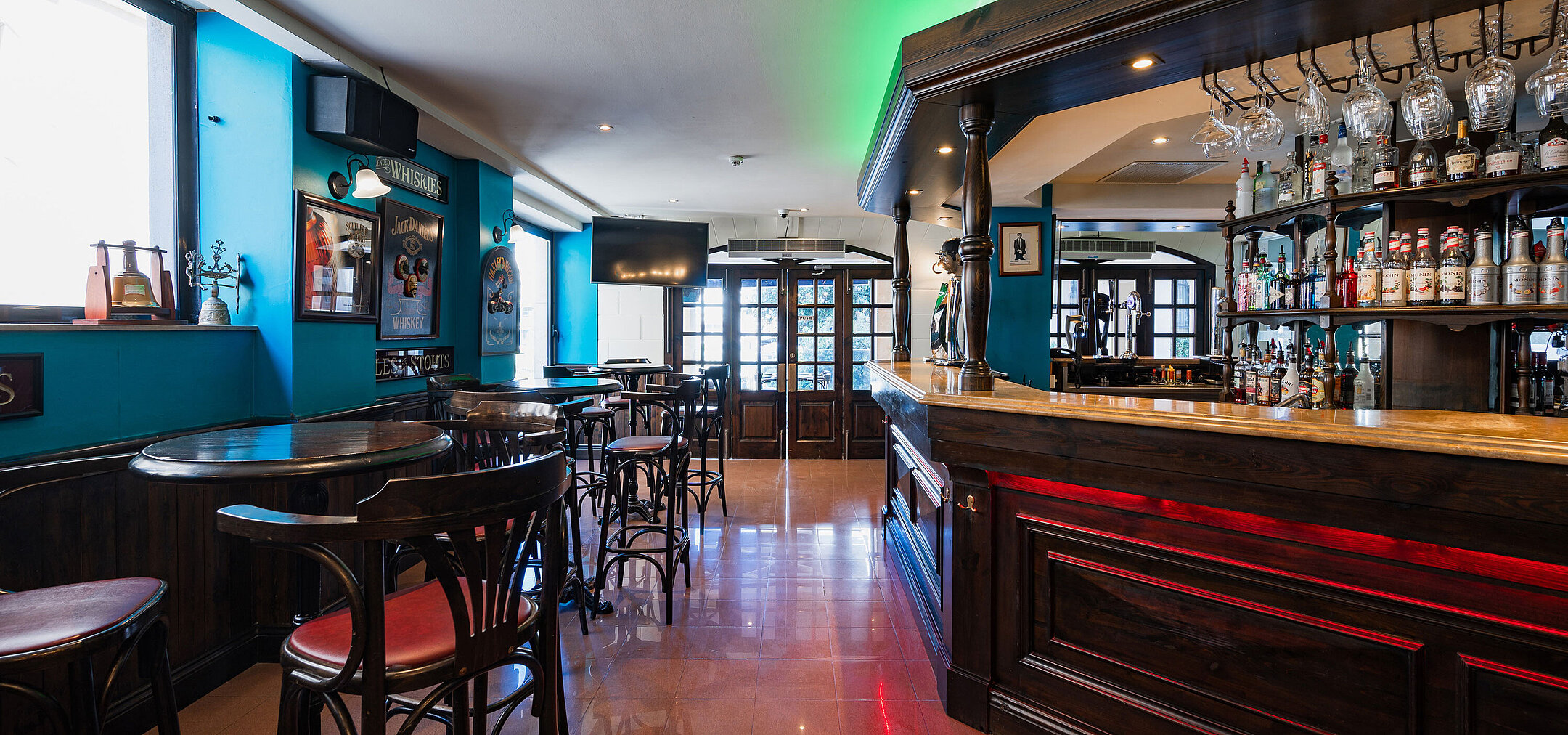 Bar Stylish pub bar at Maritim Antonine Hotel & Spa Malta featuring dark wood interiors, a selection of spirits and cosy seating areas.