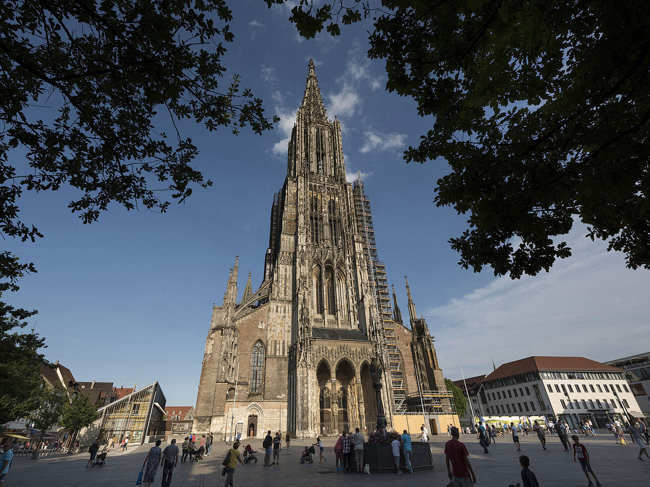 Ulm Minster View of the impressive Ulm Minster, the tallest church in the world, with people on Münsterplatz.