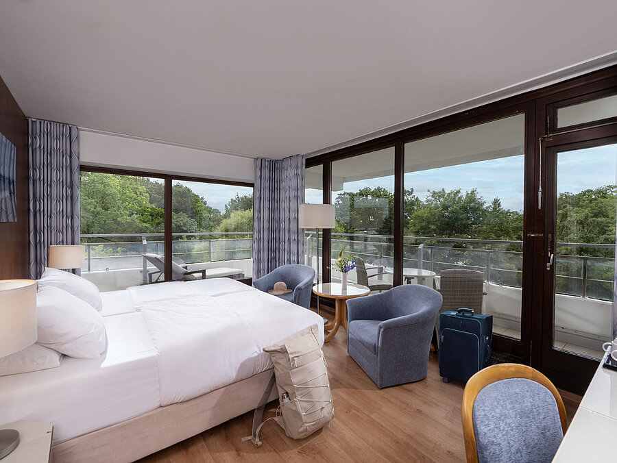 Modern double room at Maritim Seehotel Timmendorfer Strand with balcony and garden view