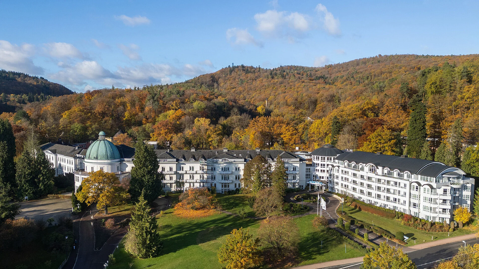 Exterior view Exterior view of the Maritim Hotel Bad Wildungen surrounded by park, trees and an autumn forest panorama.