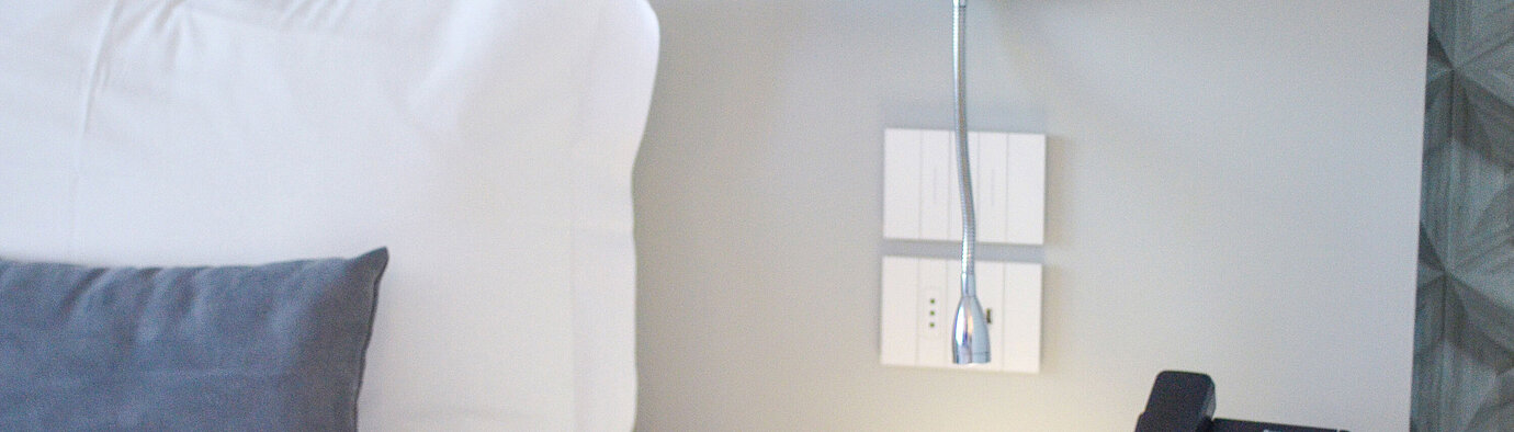 Standard room Close-up of nightstand at Maritim Resort Calabria with phone and LED reading lamp