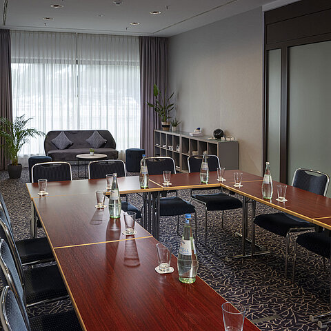 Modern conference room at Maritim Hotel Darmstadt with natural light, elegant design, and equipped for meetings or workshops.