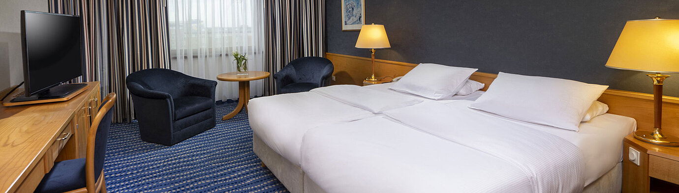 Comfort room Comfort double room with seating area, desk, and modern artwork on the wall