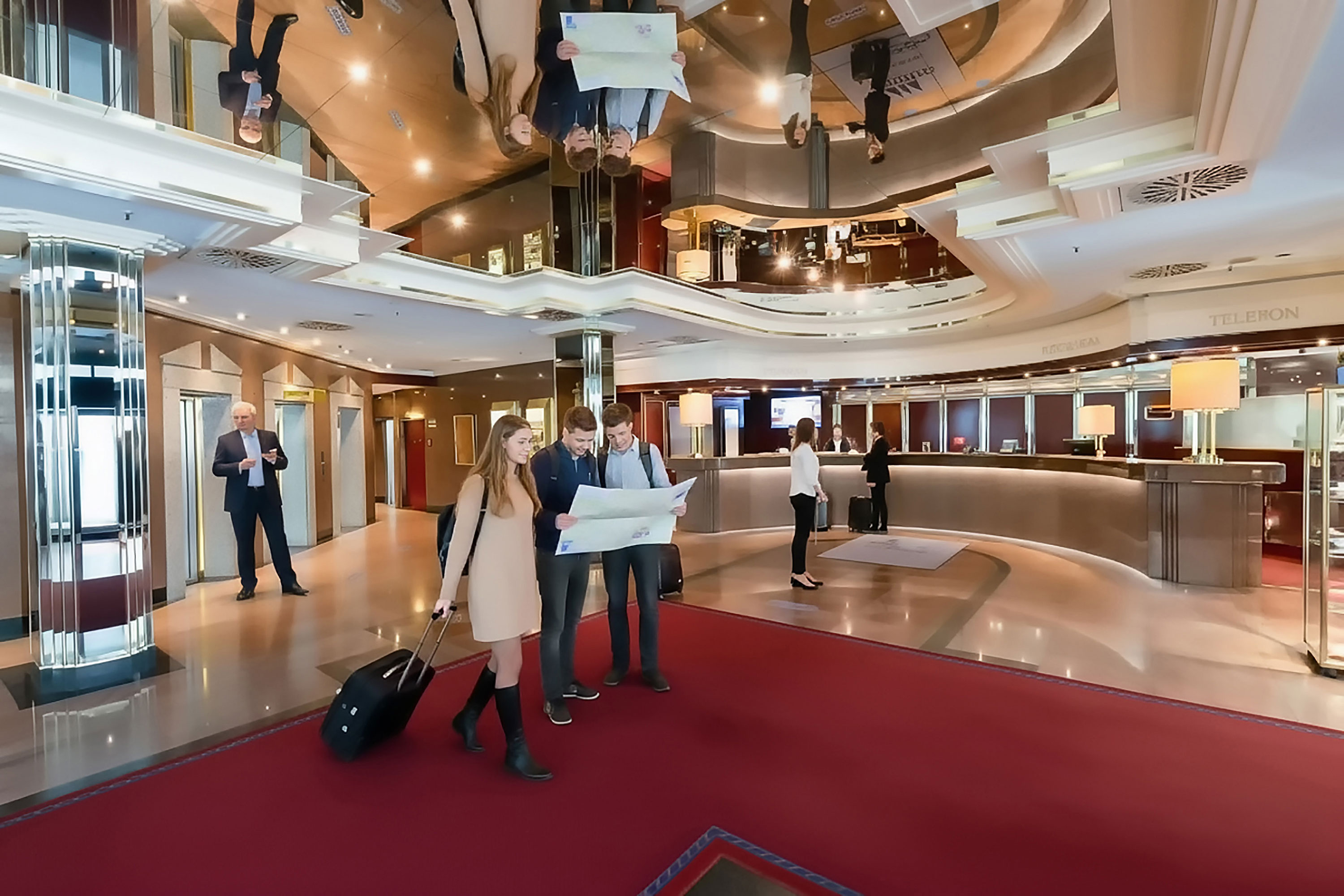 Guests check in at the modern lobby of the Maritim Hotel München.